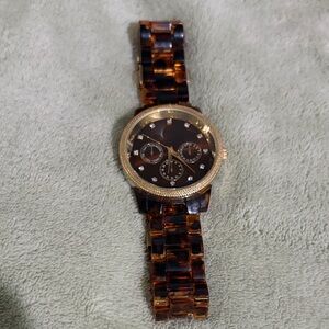 Gold and Brown women’s tortoise watch.